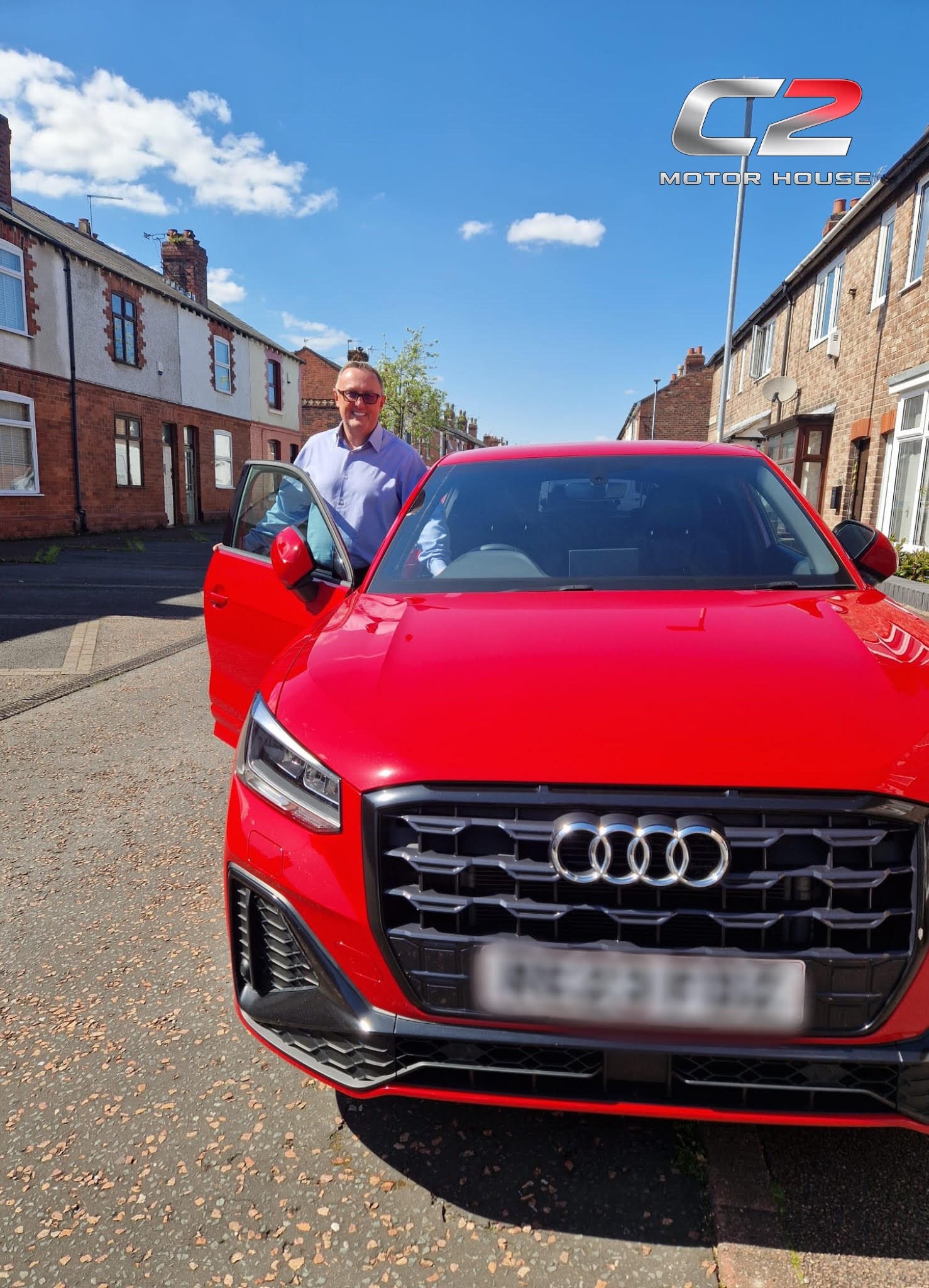 Happy customer with red Audi Q2